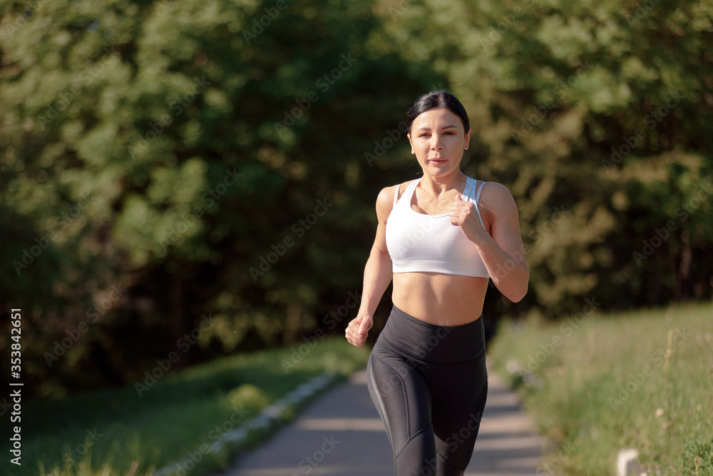 Beautiful young female runner in the green forest. Beautiful young female runner in the green forest.