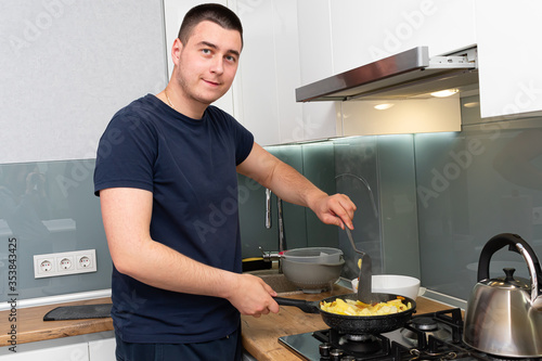 young man cooking in the kitchen