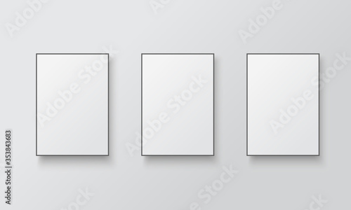 White posters with black frame mockup.  Empty white A4 sized paper hanging on gray wall