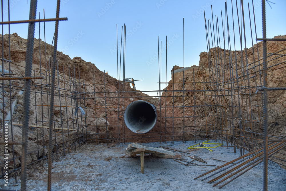 Formwork solutions for reinforced framed superstructure. Construction storm sewer concrete bunker for gate valves. Laying of underground pipes in ditch. Installation of water main and sanitary sewer