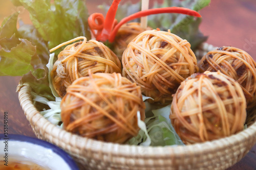 Bild auf Leinwand Deep Fried Wrapped Pork with Chinese Noodle or Fried pork ball with noodle or Moo Sarong with sweet chili sauce, authentic recipes, classical Thai cuisine
