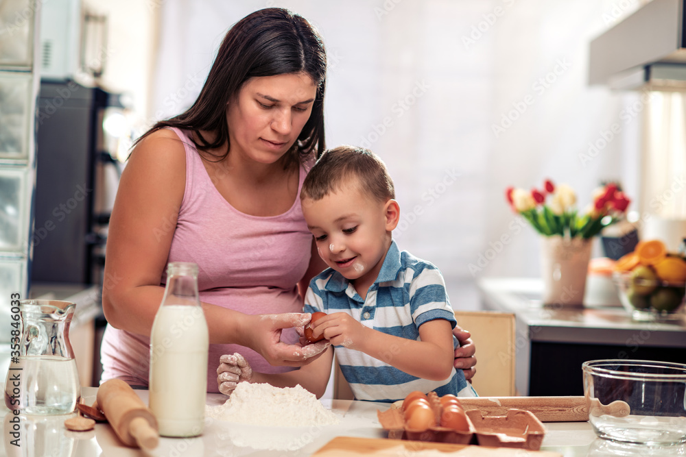 Family cooking together in modern home kitchen