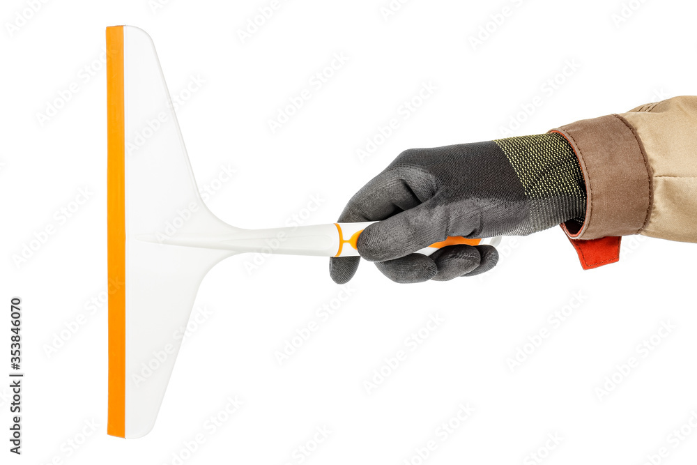 Man hand in black protective glove and brown uniform with plastic window scraper isolated on white background Man hand in black protective glove and brown uniform with plastic window scraper isolated on white background