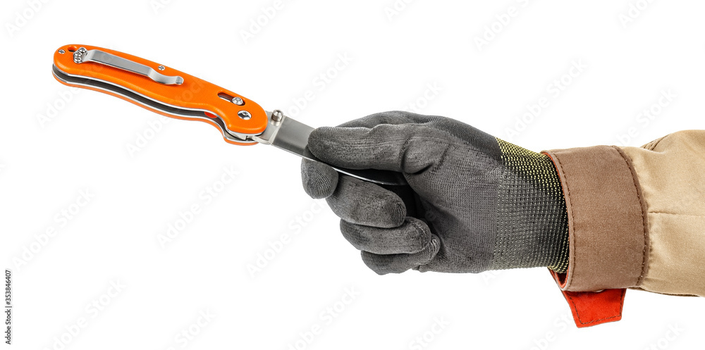 Worker hand in black protective glove and brown uniform holding by fingers blade of open pocket knife with bright orange handle isolated on white background Worker hand in black protective glove and brown uniform holding by fingers blade of open pocket knife with bright orange handle isolated on white background