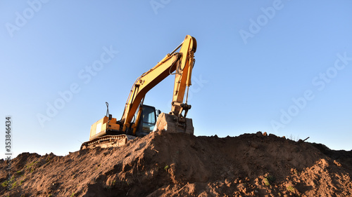 Leinwand Poster Excavator working at construction site
