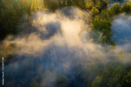Misty landscape aerial view. Foggy summer morning above river. Nature scenery