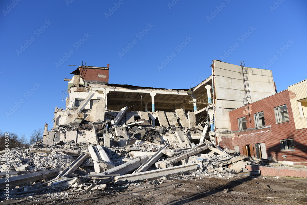 View of the demolition of a multi-storey building. Dismantling and demolition of buildings and structures. Destroy concrete
