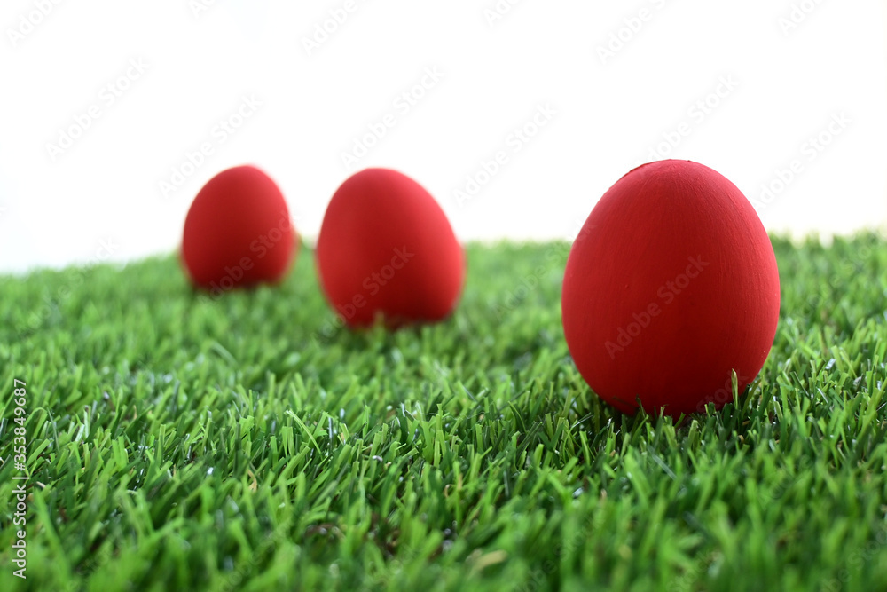 red easter egg on lawn green grass artificial with blank white background red easter egg on lawn green grass artificial with blank white background