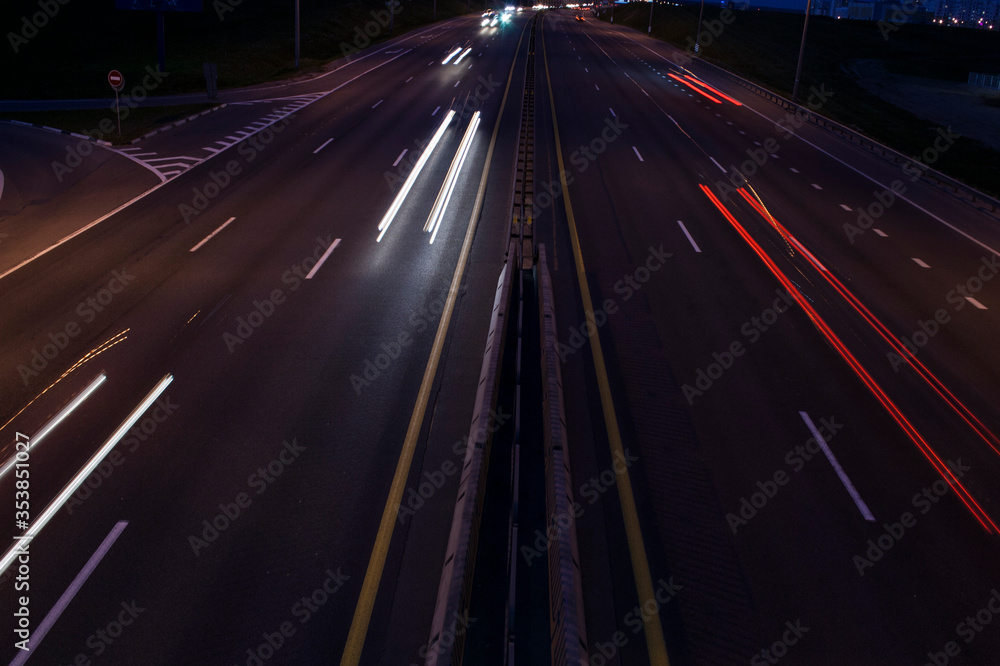 Machines in a pool of light traveling on night highway