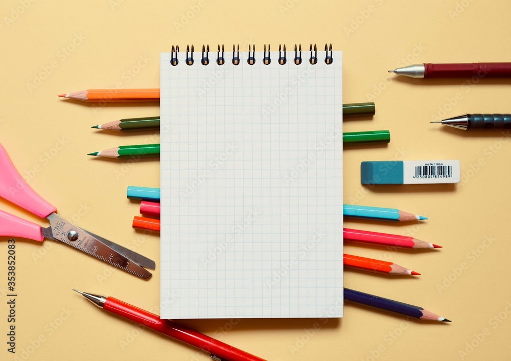 School stationery and space for text on a beige background. The view from the top. School stationery and space for text on a beige background. The view from the top.