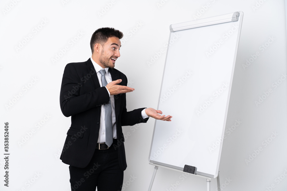 Young man giving a presentation on white board and with surprise expression Young man giving a presentation on white board and with surprise expression