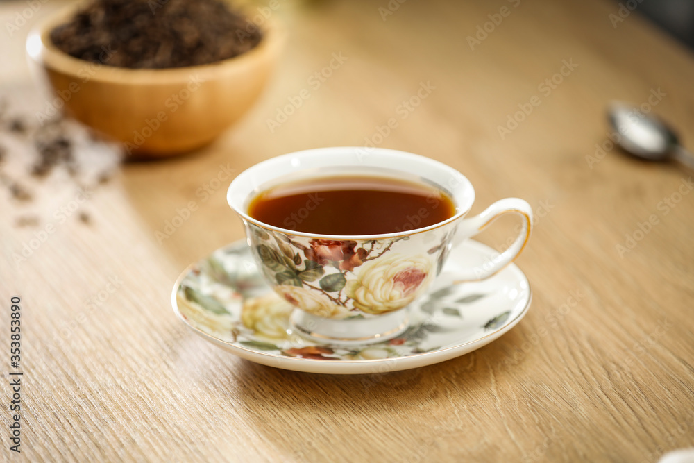 Hot tea on a wooden table in a glass brewer Hot tea on a wooden table in a glass brewer