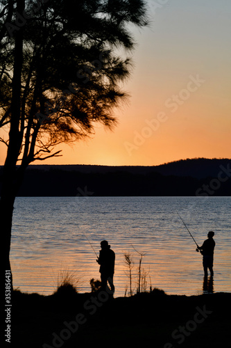 silhouette of a man fishing at sunset
