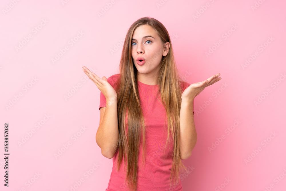 Teenager blonde girl over isolated pink background with surprise facial expression Teenager blonde girl over isolated pink background with surprise facial expression