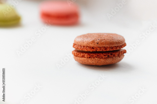 Brown chocolate macaroon cookie isolated on white background. French gluten free dessert
