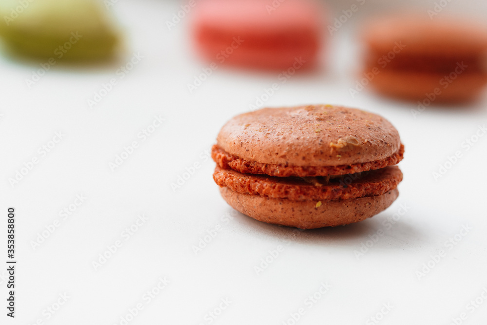 Brown chocolate macaroon cookie isolated on white background. French gluten free dessert Brown chocolate macaroon cookie isolated on white background. French gluten free dessert