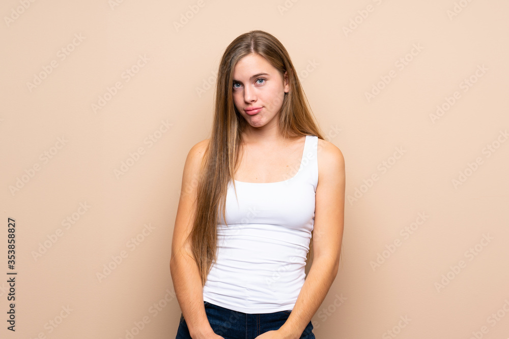 Teenager blonde girl over isolated background with sad and depressed expression Teenager blonde girl over isolated background with sad and depressed expression