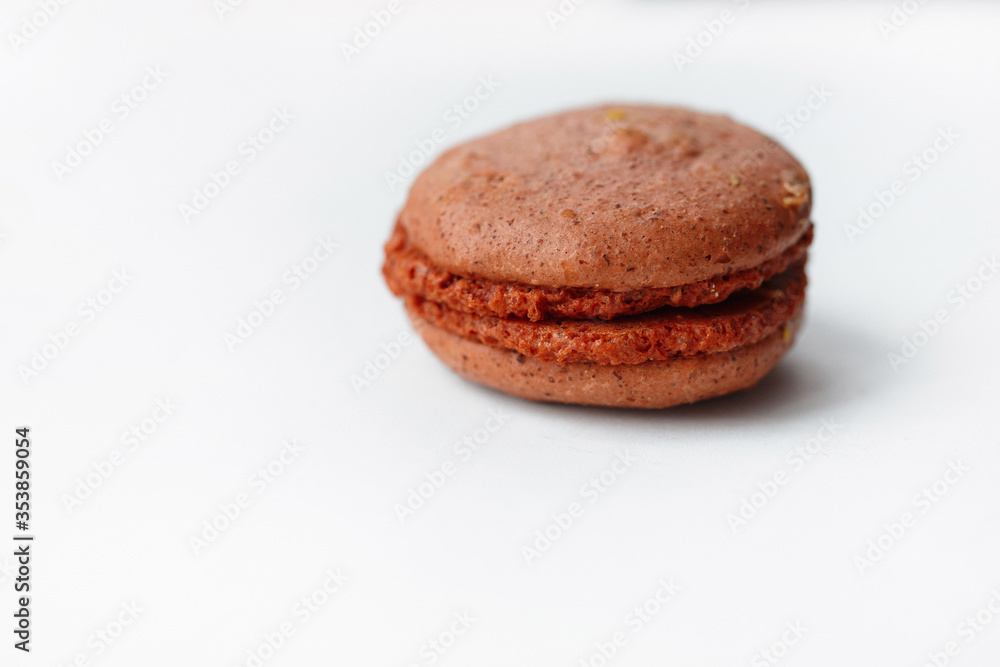 Brown chocolate macaroon cookie isolated on white background. French gluten free dessert Brown chocolate macaroon cookie isolated on white background. French gluten free dessert