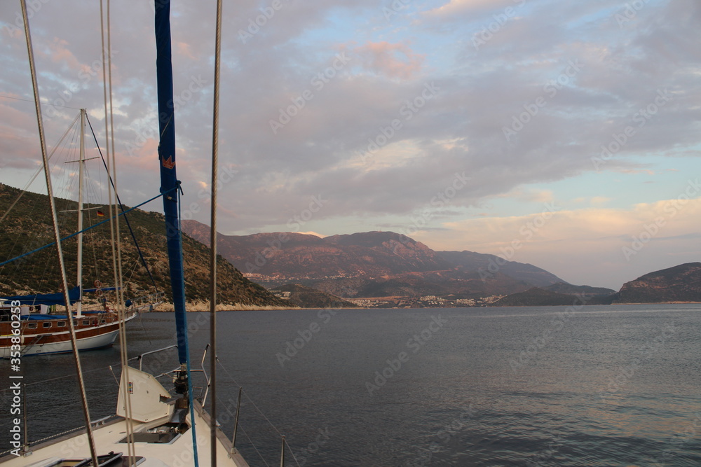 Sailing boats at sunset near Firnaz Koyu, at theKalkan bay, Turkey