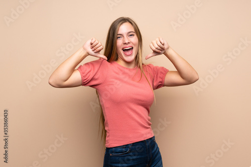 Teenager blonde girl over isolated background proud and self-satisfied