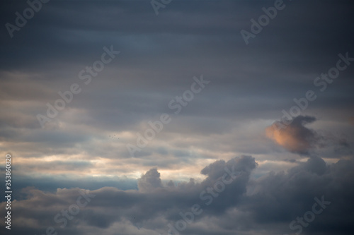 Fluffy clouds cover the summer blue sky