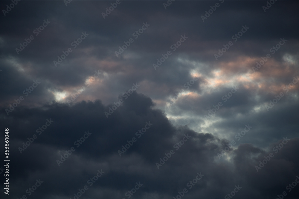 Fluffy clouds cover the summer blue sky