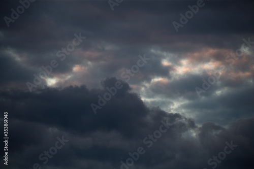 Fluffy clouds cover the summer blue sky