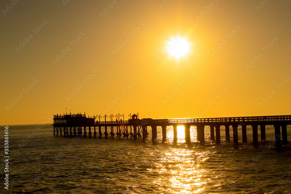 Pier or jetty at sunset / sunrise over sea