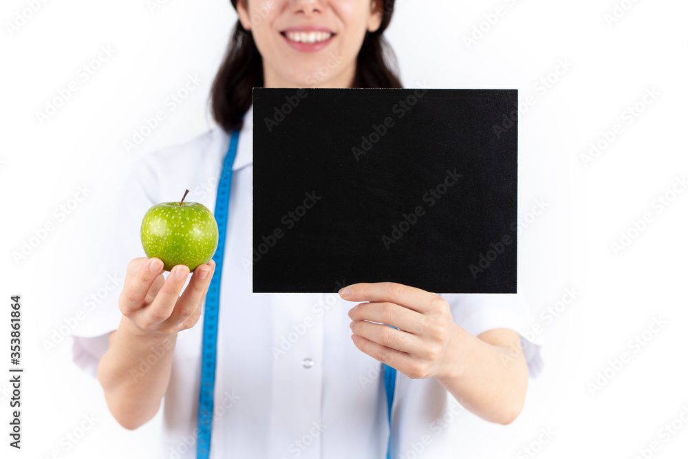 young female dietician, nutritionist doctor. She is holding an empty blackboard in her hand. online diet and healthy eating concept.
young female dietician, nutritionist doctor. She is holding an empty blackboard in her hand. online diet and healthy eating concept.