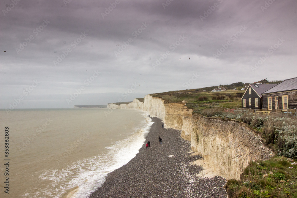 White cliffs with people on grey pebble beach