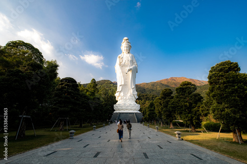 Guan Yin statue in Tsz Shan Monastery with worshipper