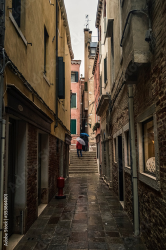 Old narrow street in Venice in the rain.