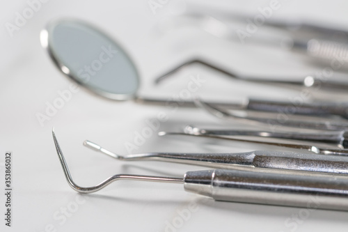 Dentist tools: mirror, dental probe and tweezers
