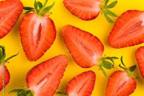  Strawberry background. Red strawberries on a bright yellow background. Food background.