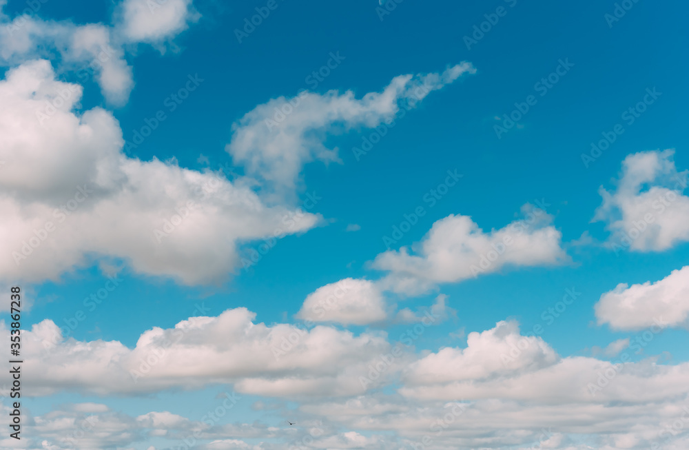 white clouds in a blue sky. Bright day, horizontal photography