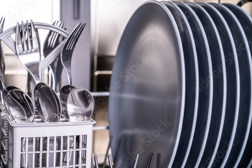 Clean plates and shiny silverware in dishwasher