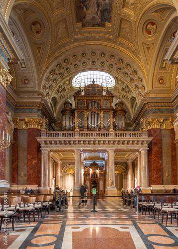 Budapest, Hungary - Feb 8, 2020: Organ pipe facade with golden fresco ceiling in St. Stephen's Basilica