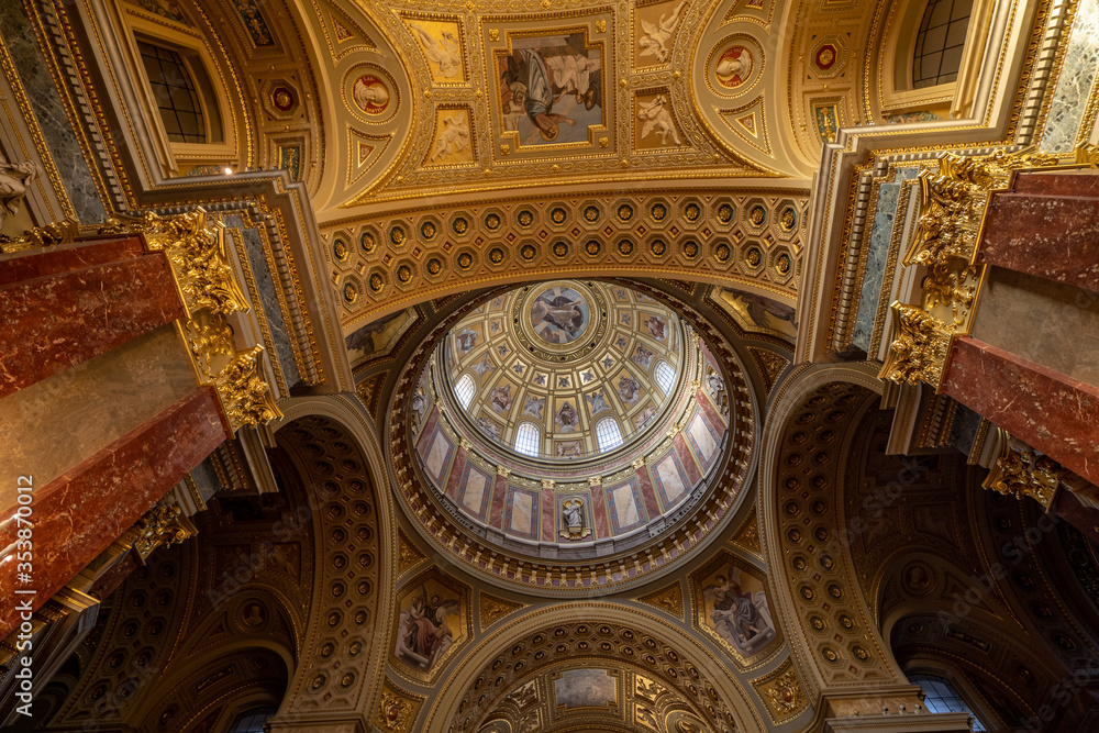 Budapest, Hungary - Feb 8, 2020: Ultrawide view of godlen dome interior of St. Stephen Basilica