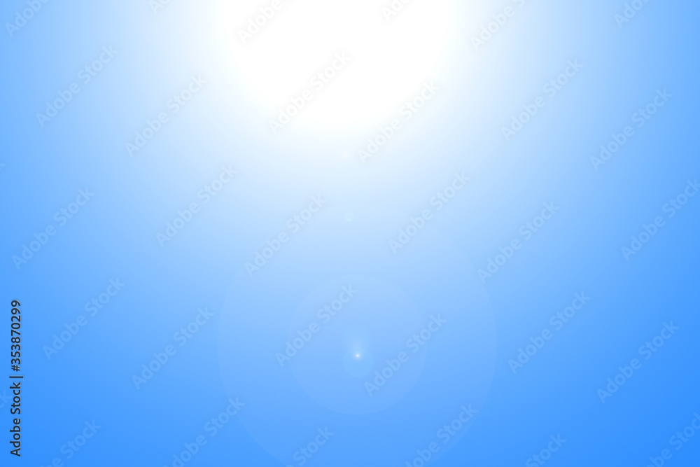Lens flares from the sun on blue clear sky, nature background