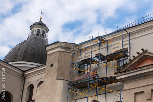 Scaffolding at the old monastery. Restoration of an architecturе. Repair work of the monastery and the baroque cathedral.