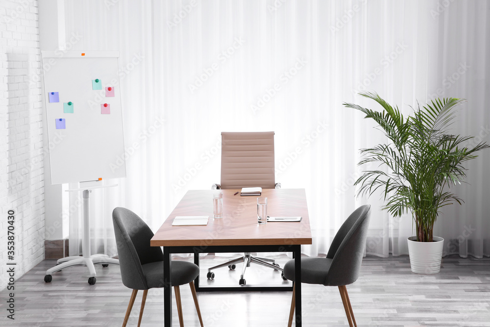 Interior of modern office with table and chairs