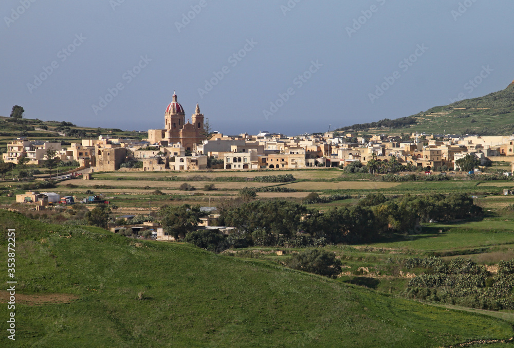 A small village with a large domed church in the countryside on Gozo, Malta
