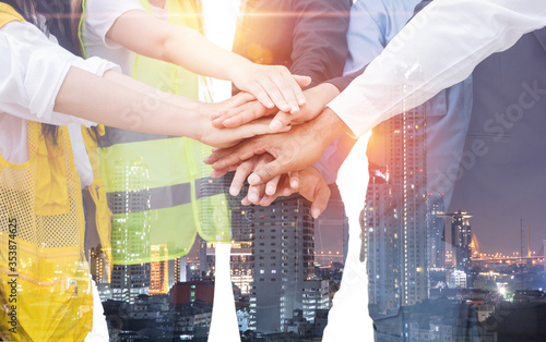 Teamwork working together joining concept multiethnic people group a meeting in the office for business cooperation on city night background.