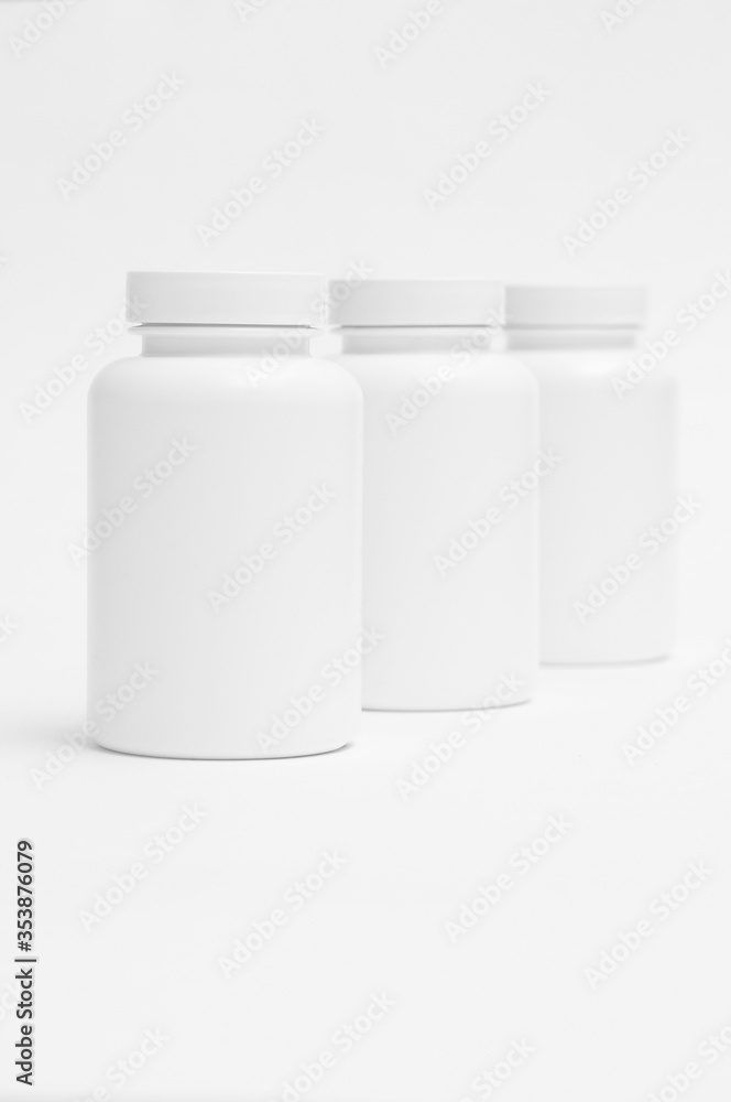 three white plastic containers for pills for healthy food one by one isolated on white background three white plastic containers for pills for healthy food one by one isolated on white background