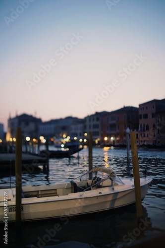 A boat docking at the river of Venice during sunset