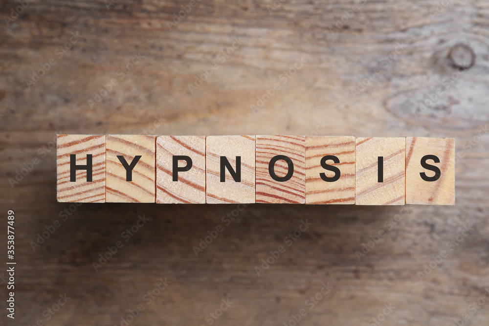 Fototapeta premium Blocks with word HYPNOSIS on wooden background, flat lay