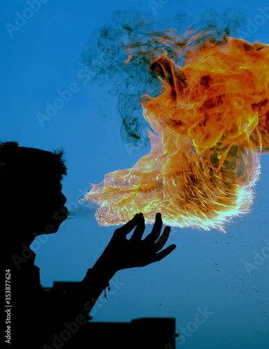 Boy spitting fire photo