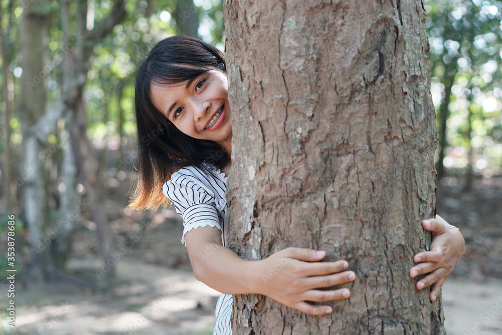 Asian women huging trees , the concept of love for the world Asian women huging trees , the concept of love for the world