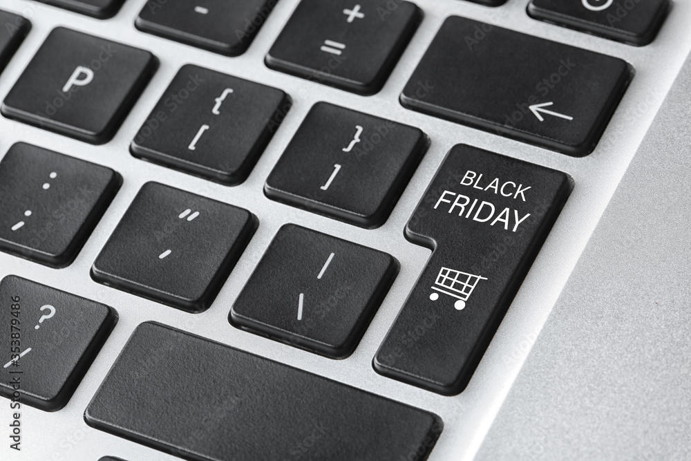 Laptop keyboard with Black Friday button, closeup. Online shopping