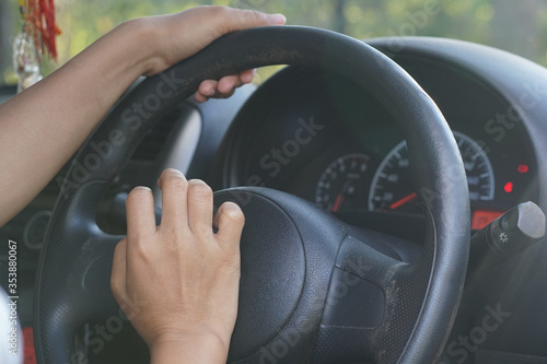 Human hands pressing the car horn 